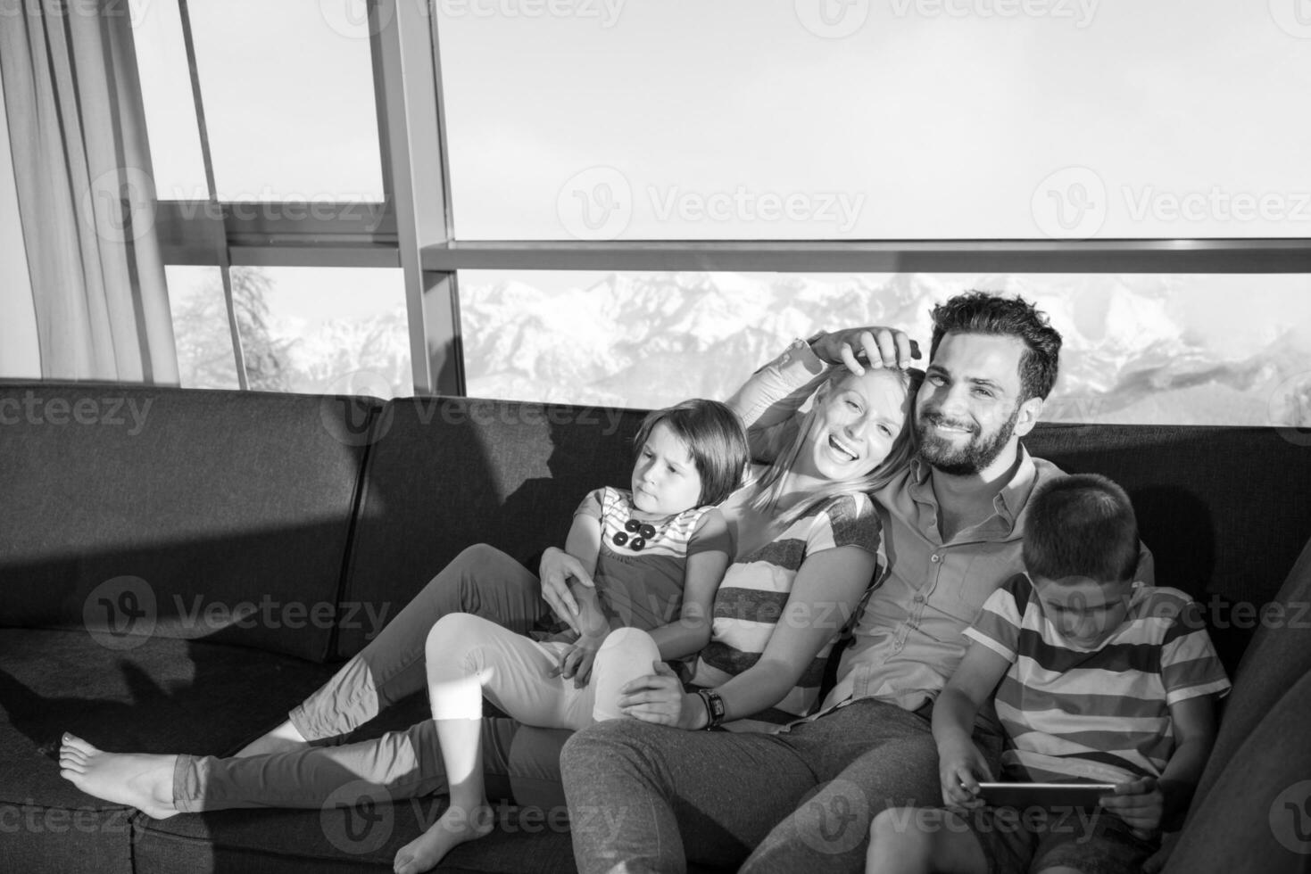 happy young couple spending time with kids at home photo