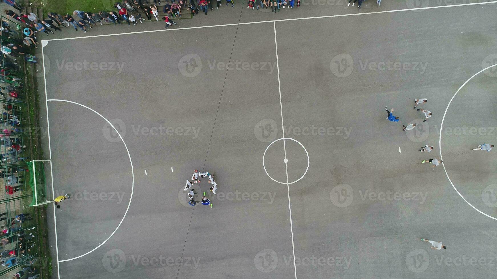 top view drone flying above amateur soccer game match. Countryside authentic tournament. photo