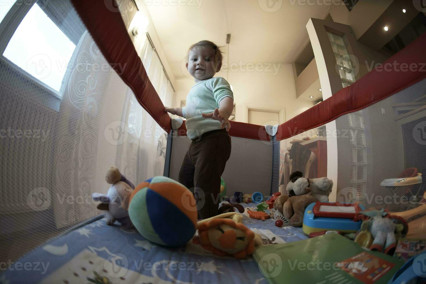 cute  little  baby playing in mobile  bed photo
