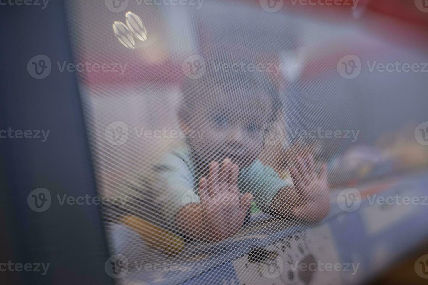 cute  little  baby playing in mobile  bed photo