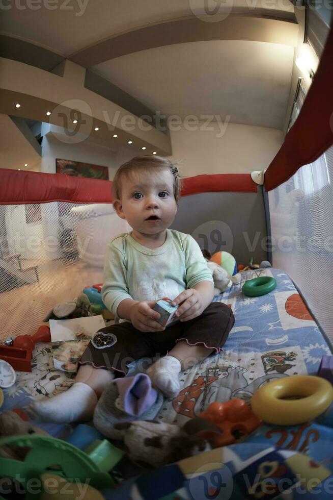 cute  little  baby playing in mobile  bed photo