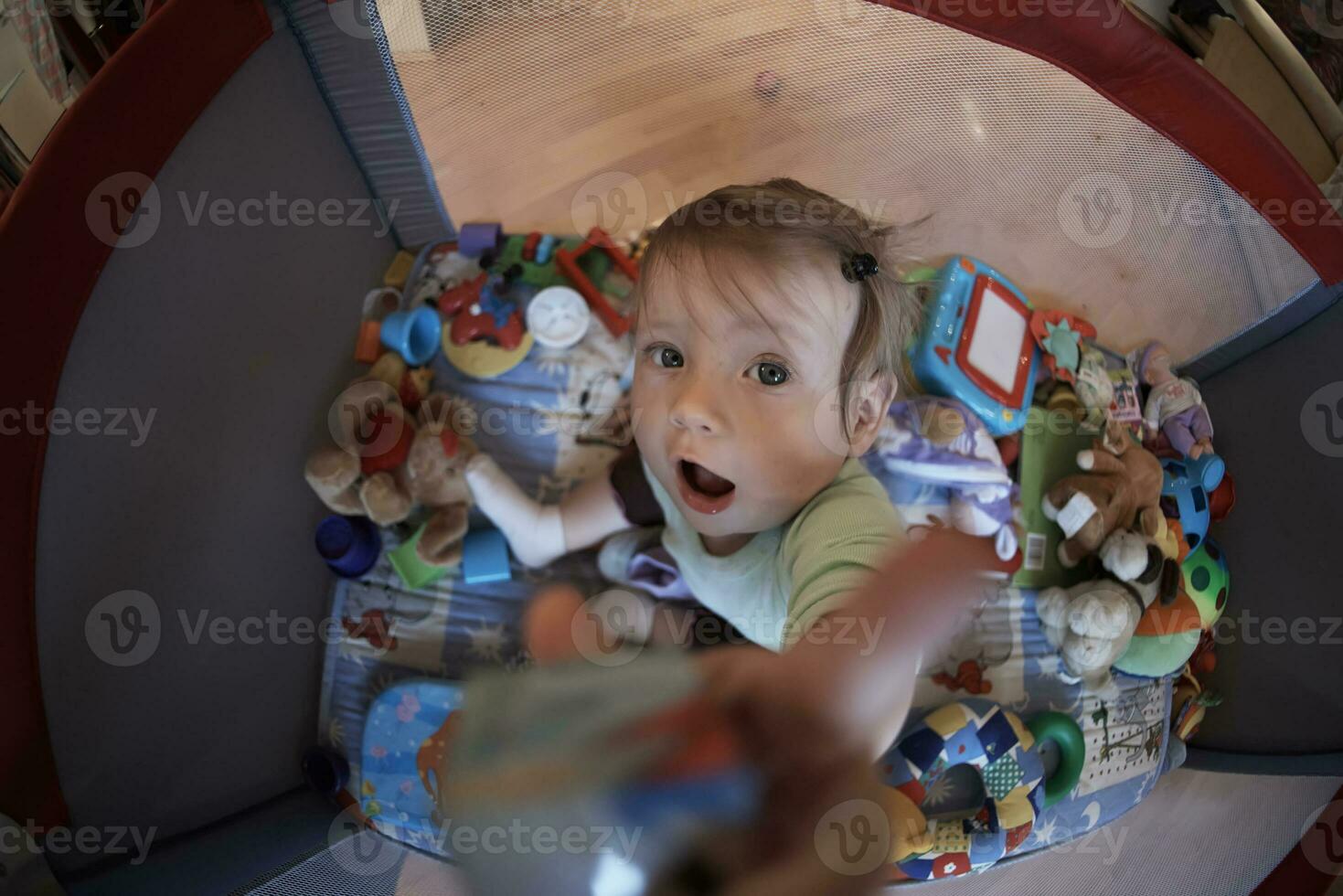 cute  little  baby playing in mobile  bed photo