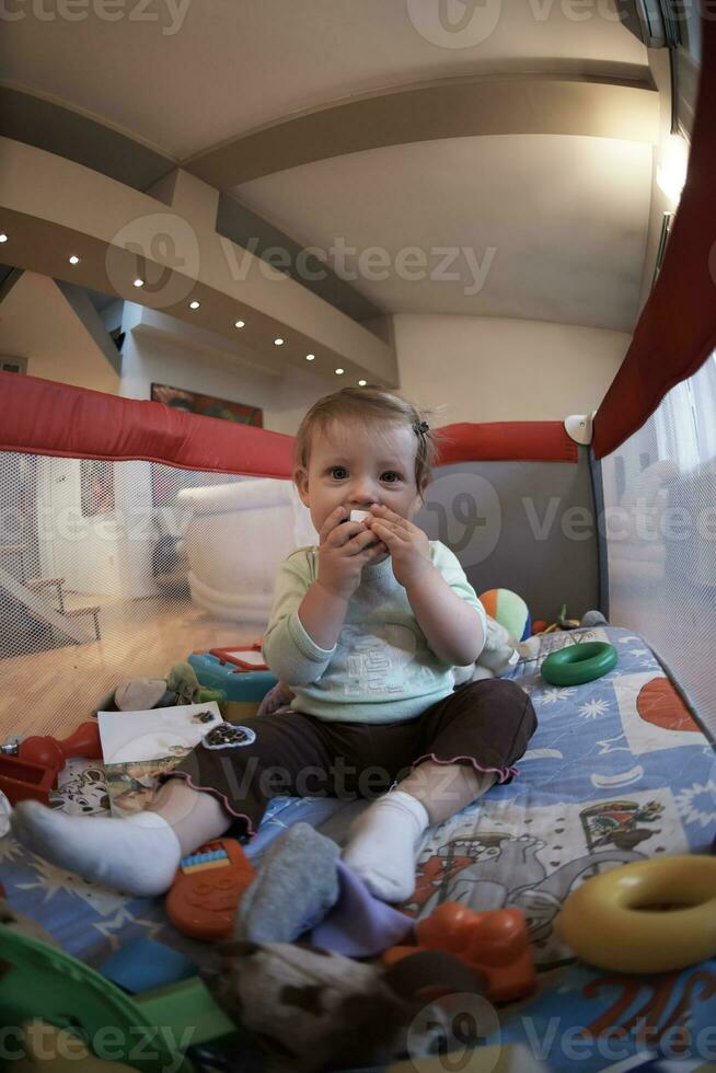 cute  little  baby playing in mobile  bed photo