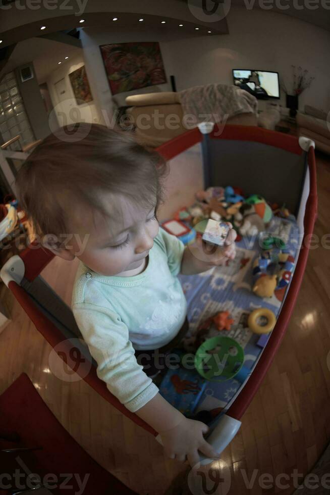 cute  little  baby playing in mobile  bed photo