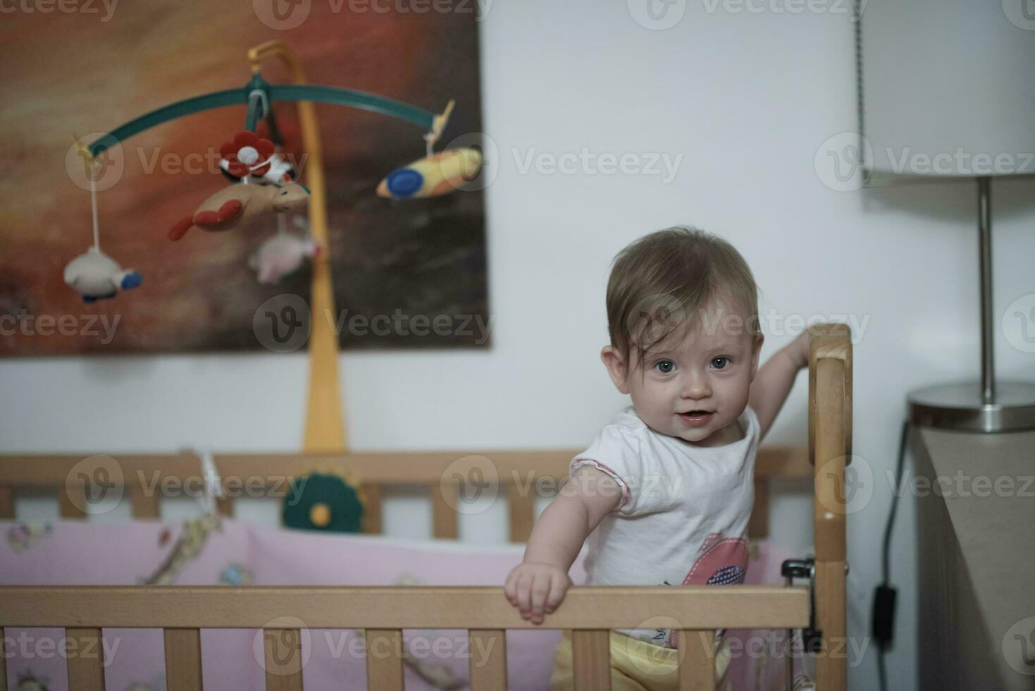 cute  little one year old baby and making first steps in bed photo