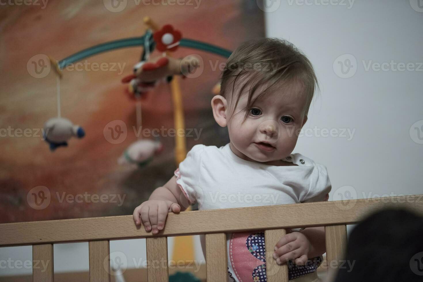 cute  little one year old baby and making first steps in bed photo