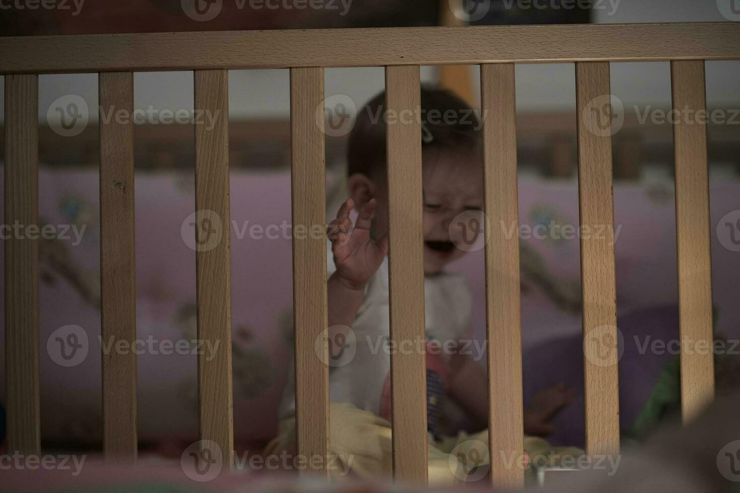 cute  little one year old baby and making first steps in bed photo