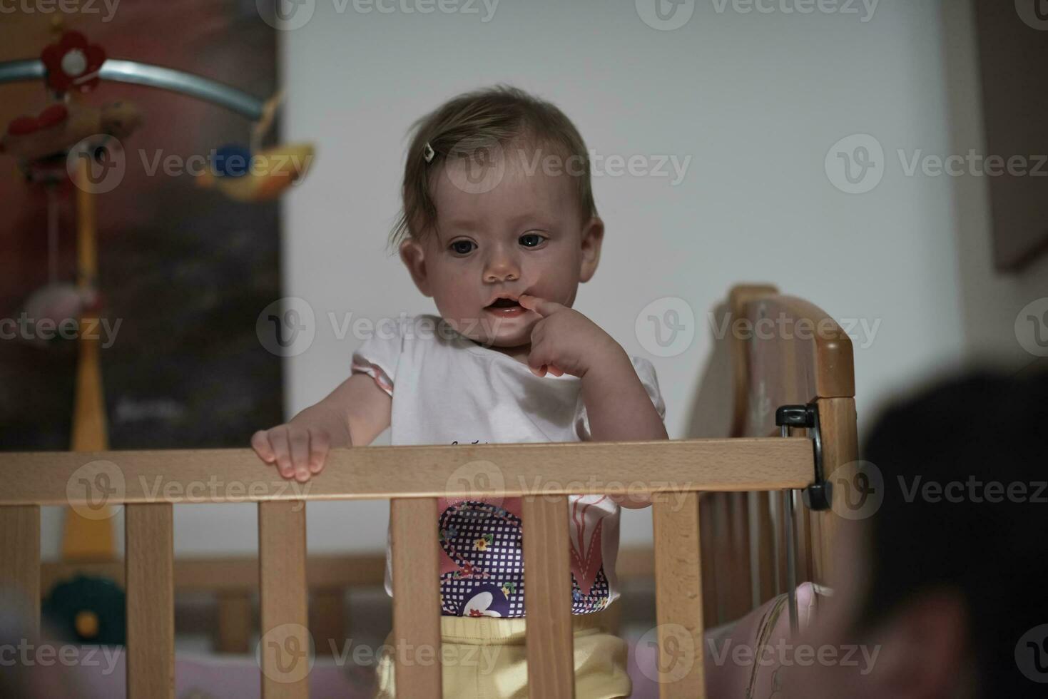 cute  little one year old baby and making first steps in bed photo