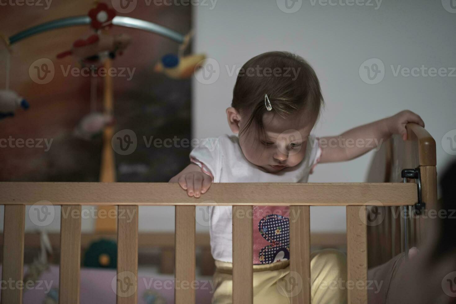 cute  little one year old baby and making first steps in bed photo