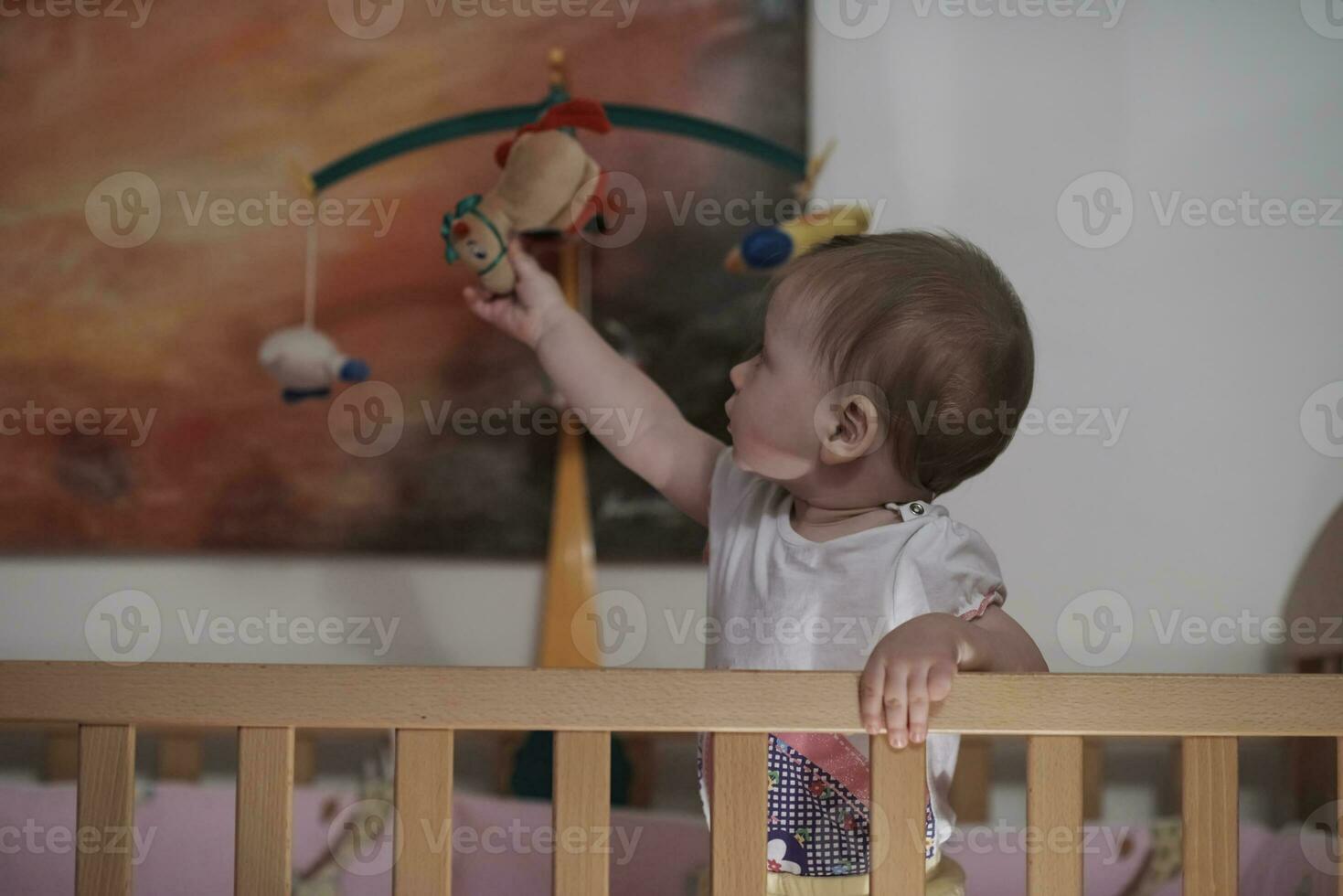 cute  little one year old baby and making first steps in bed photo