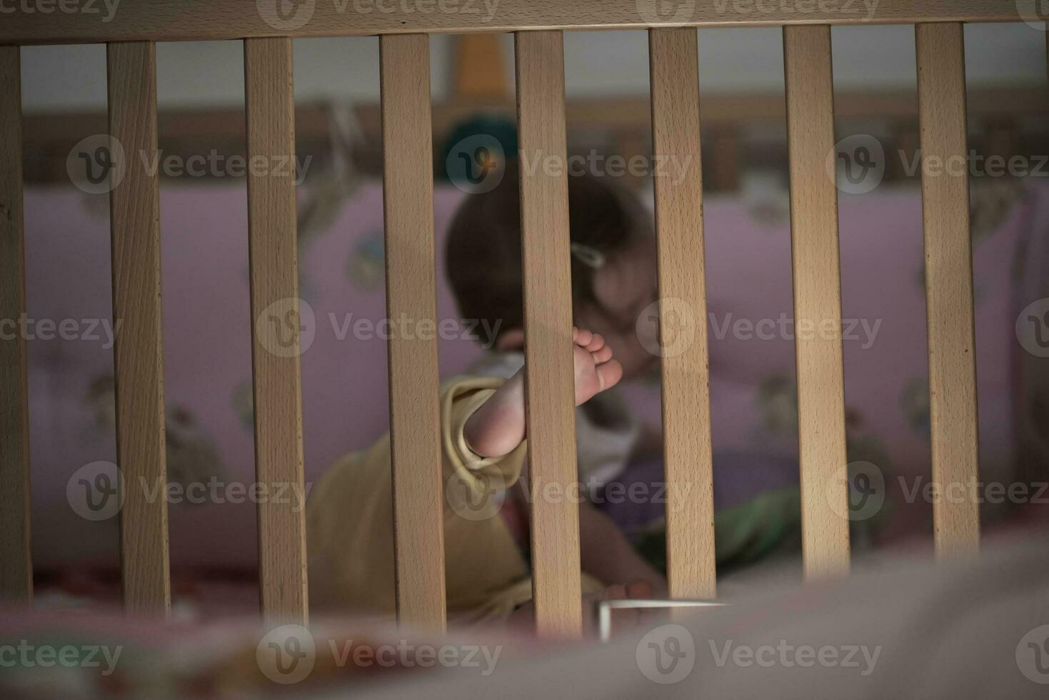 cute  little one year old baby and making first steps in bed photo