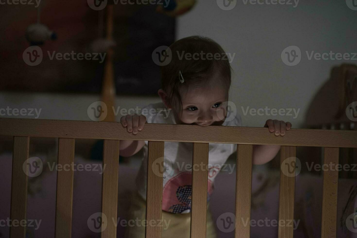 cute  little one year old baby and making first steps in bed photo