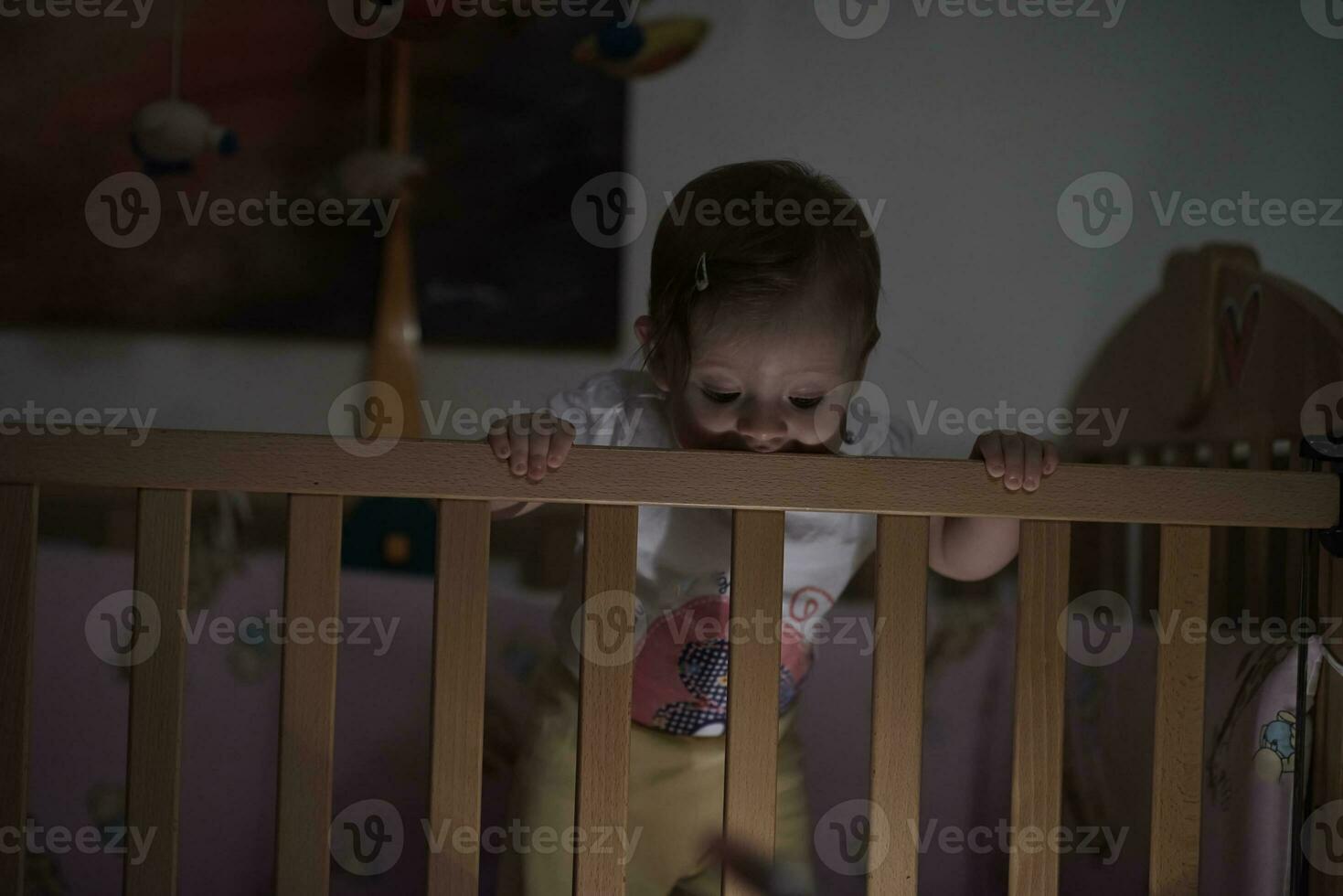 cute  little one year old baby and making first steps in bed photo