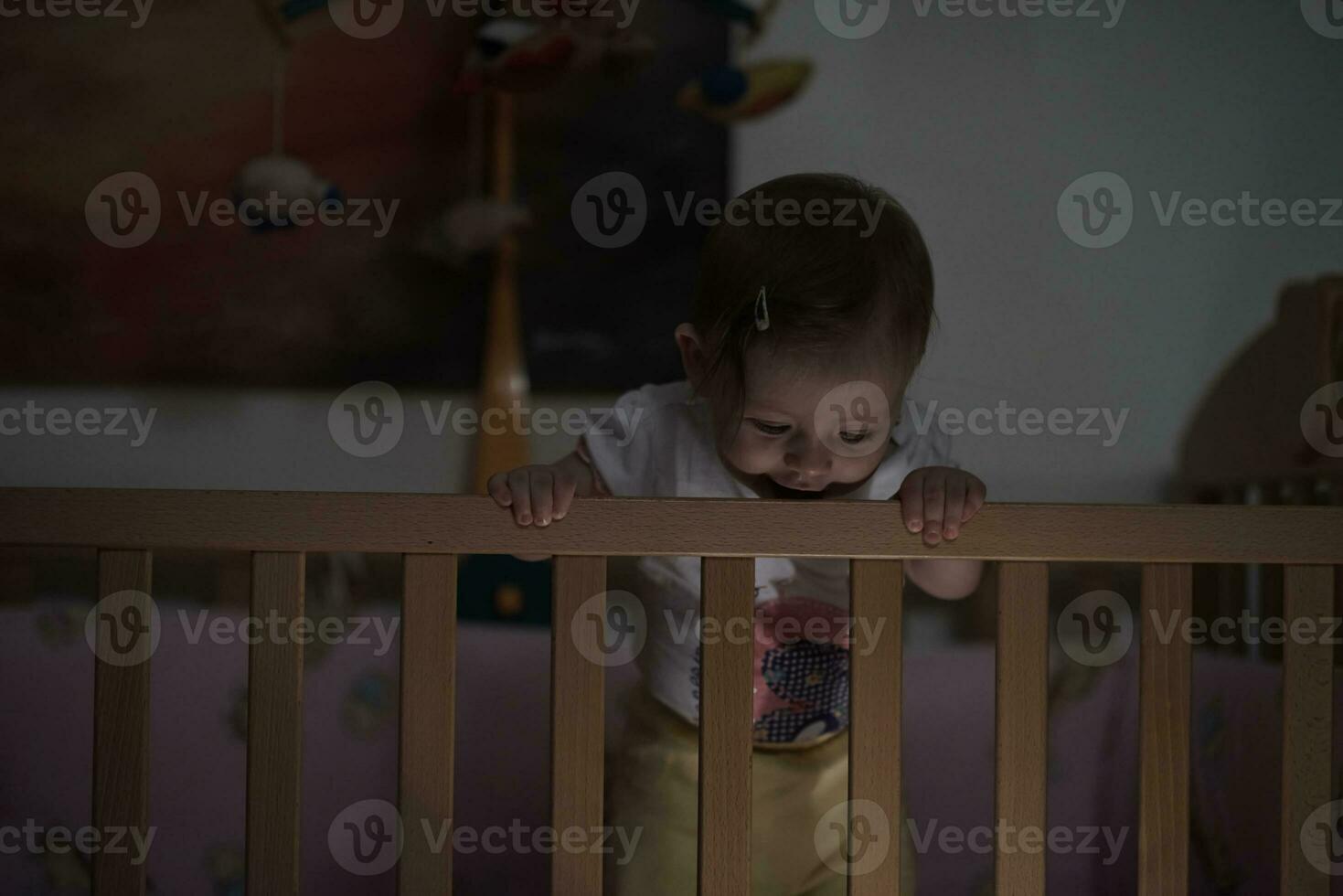 cute  little one year old baby and making first steps in bed photo
