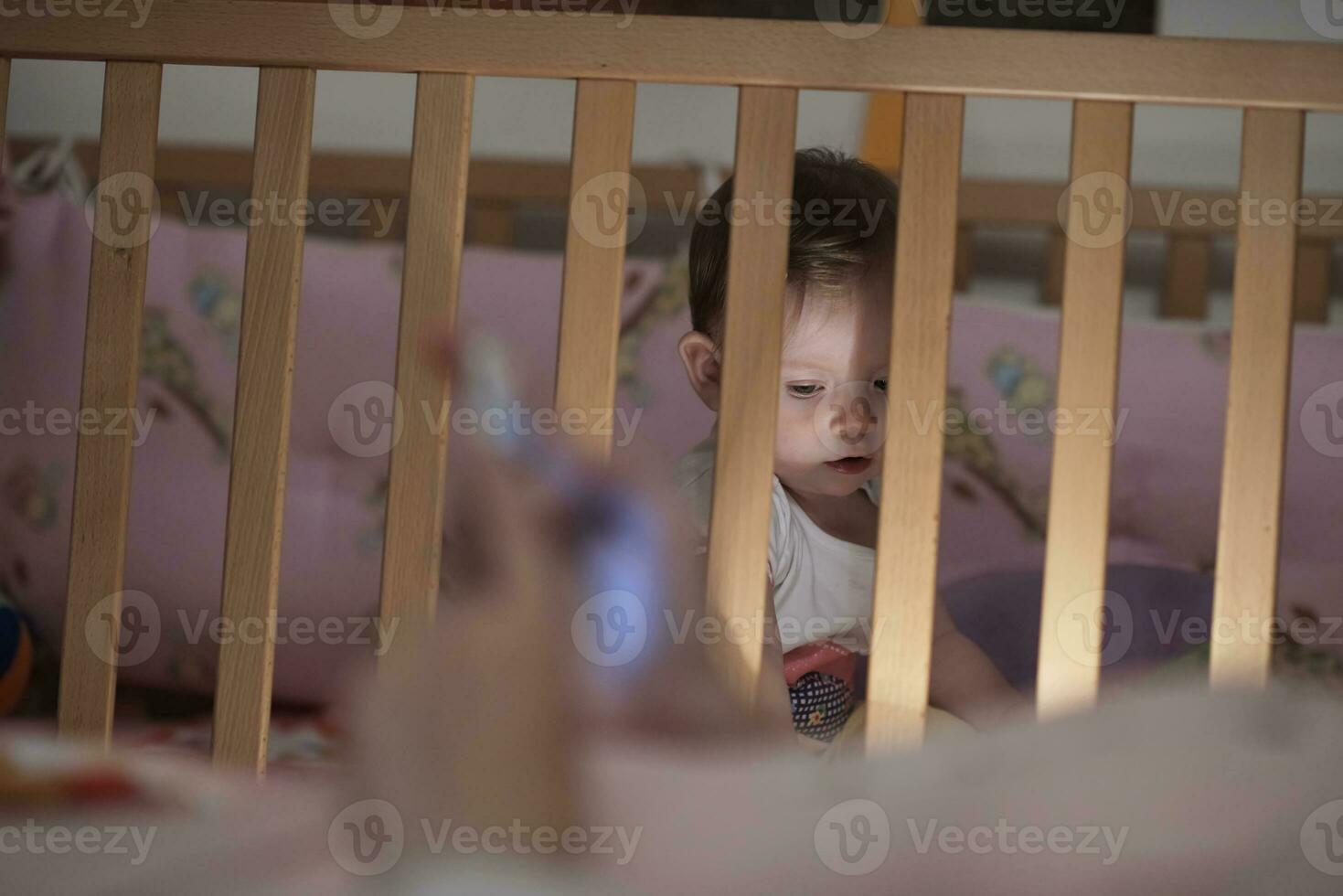 cute  little one year old baby and making first steps in bed photo