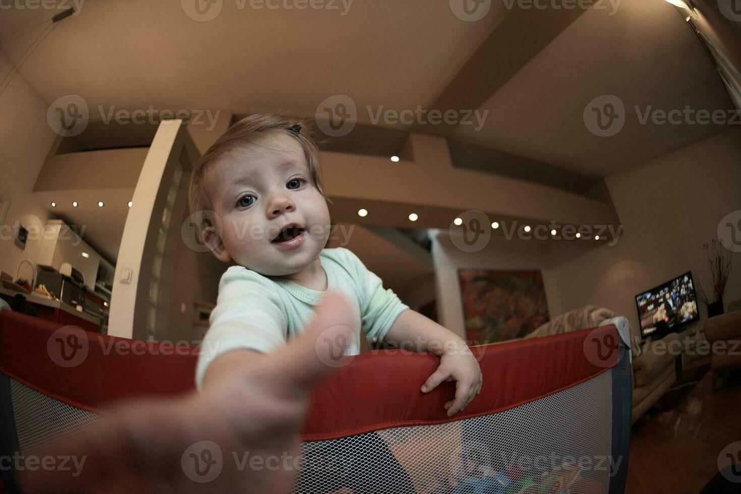 cute  little  baby playing in mobile  bed photo