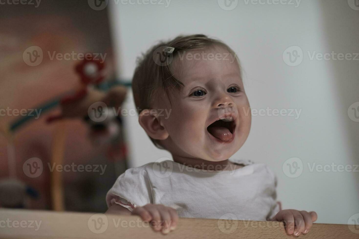 cute  little one year old baby and making first steps in bed photo