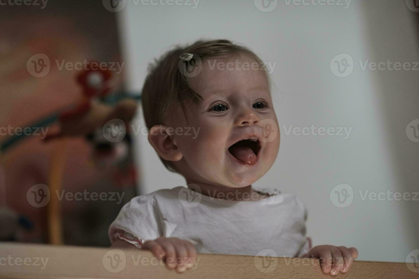 cute  little one year old baby and making first steps in bed photo