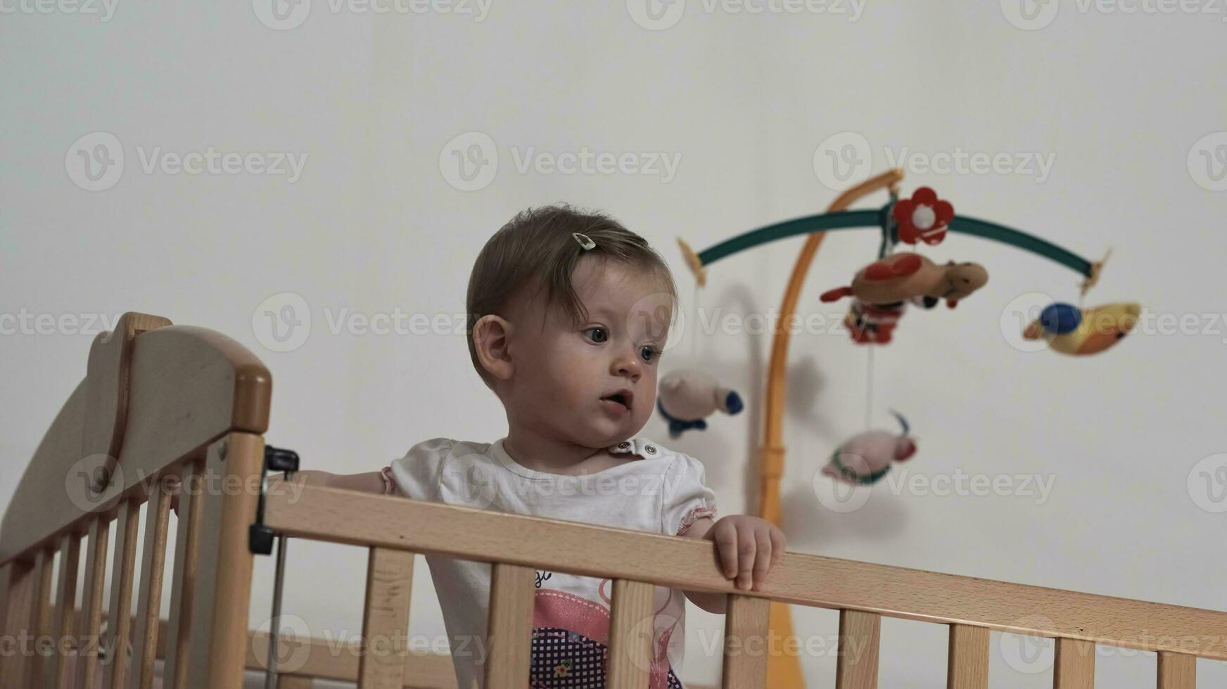 cute  little one year old baby and making first steps in bed photo