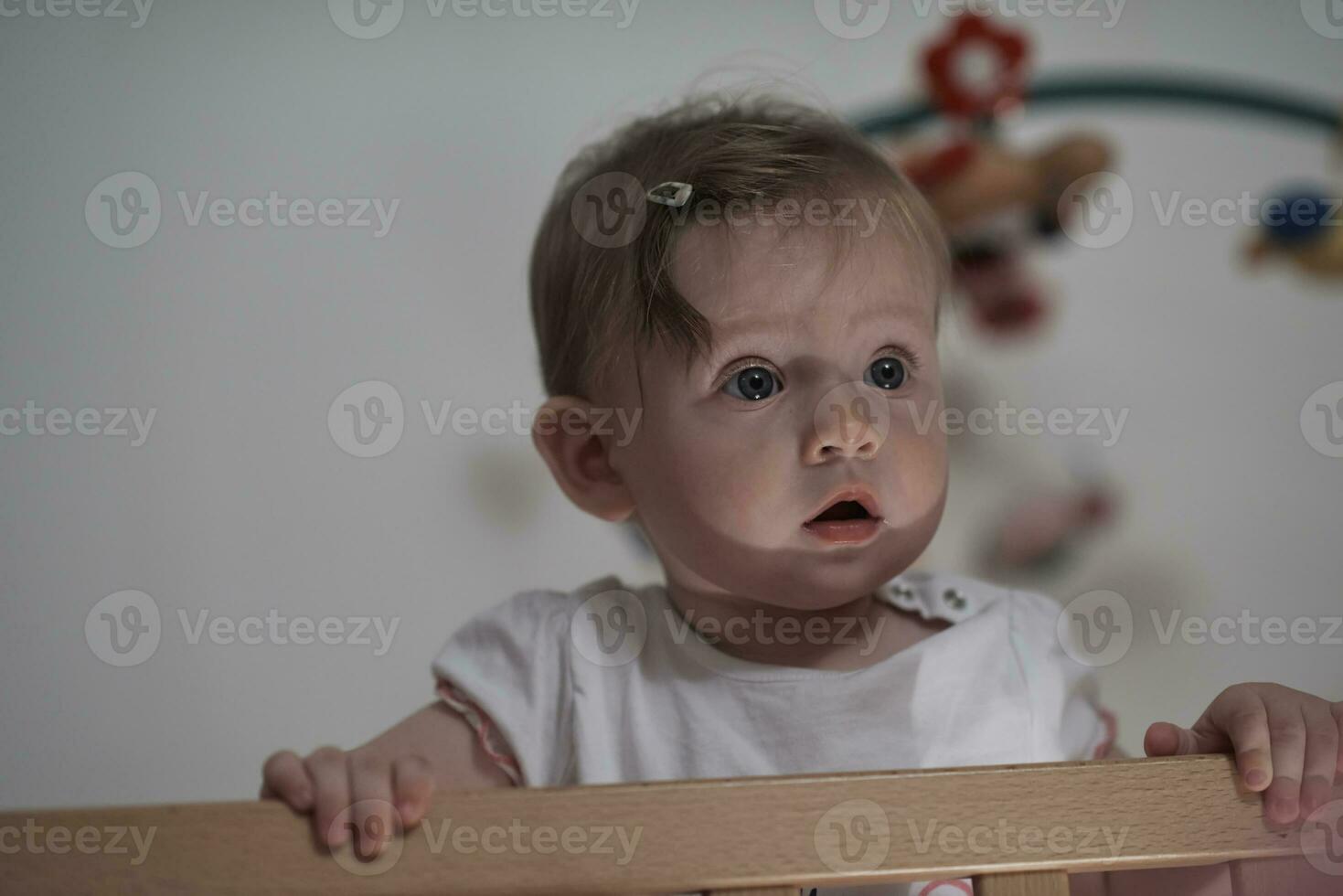 cute  little one year old baby and making first steps in bed photo