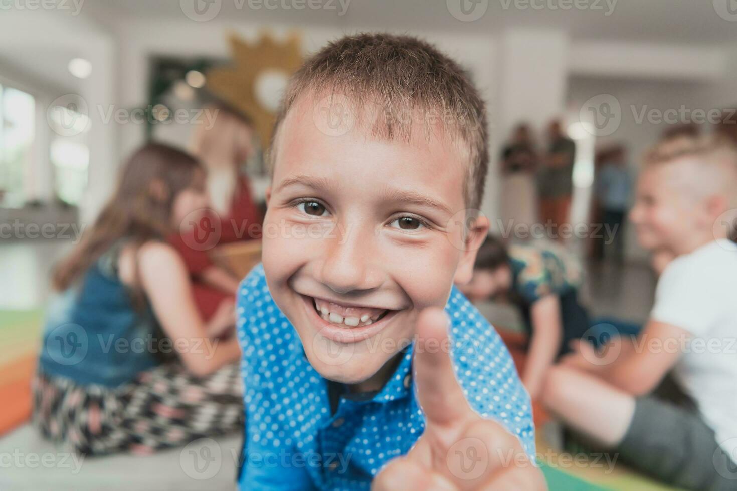 Portrait photo of a smiling boy in a preschool institution having fun