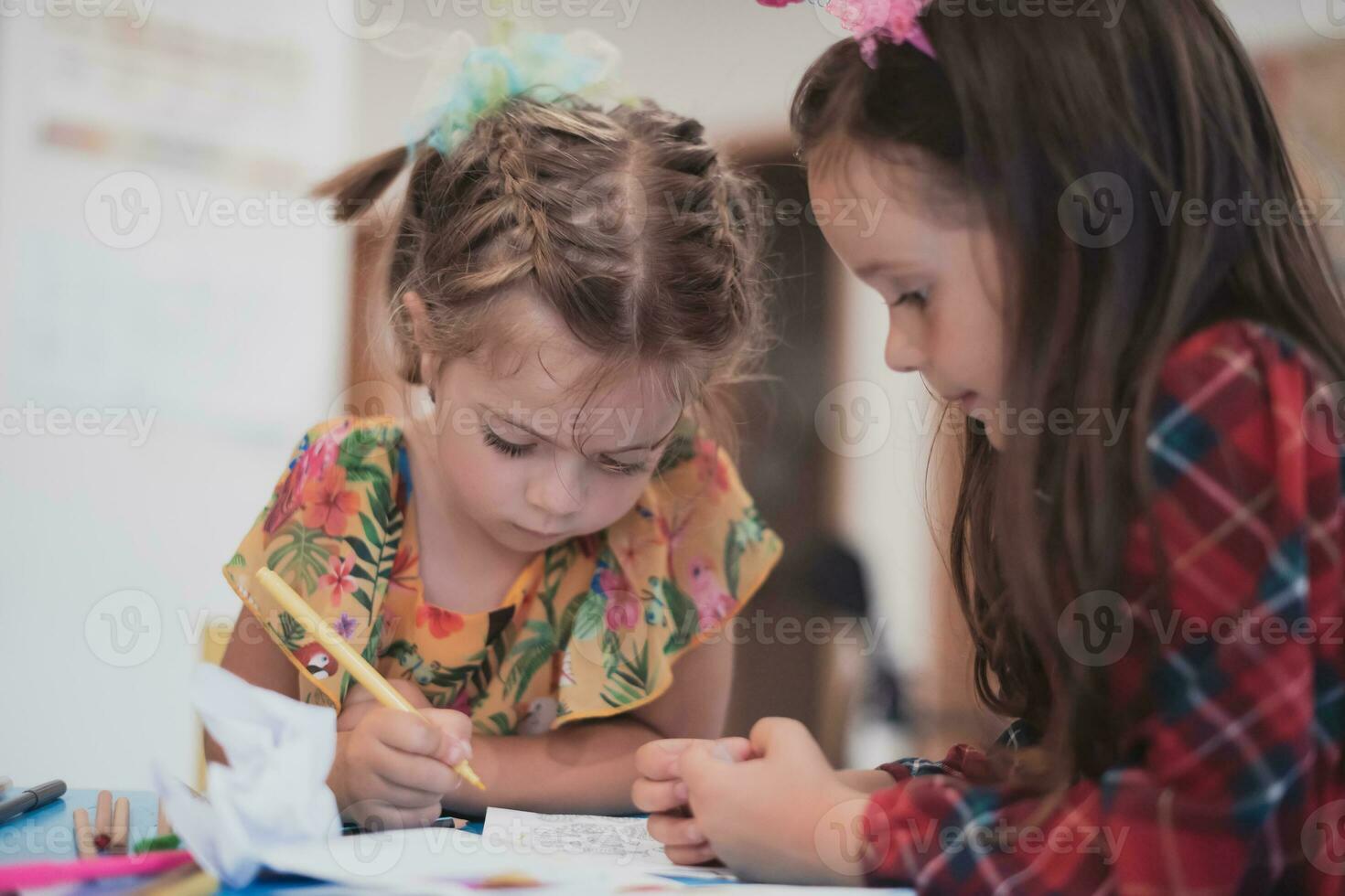 Creative kids sitting in a preschool institution, draw and have fun while they get an education photo
