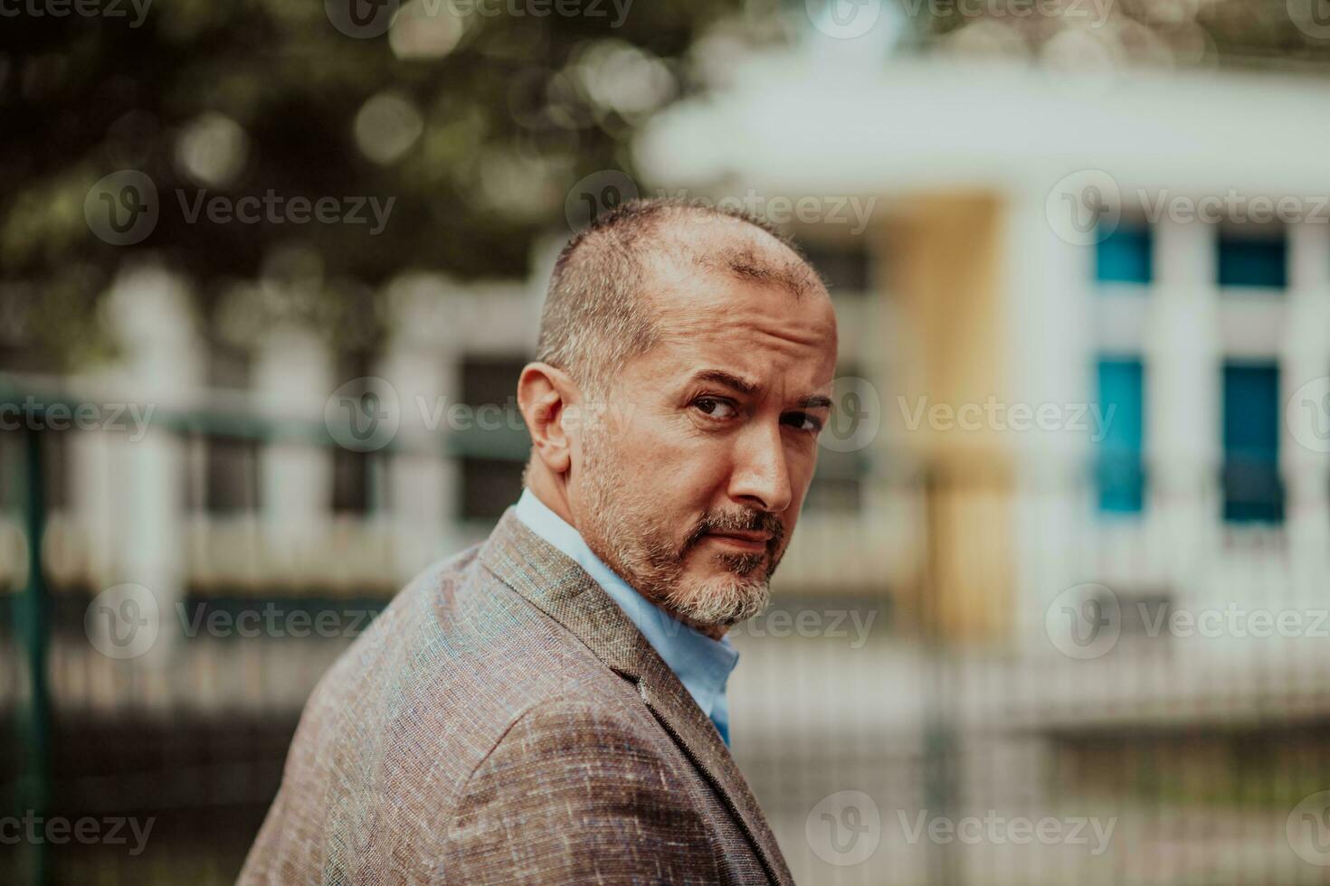 Focused businessman in a suit walking in the park photo