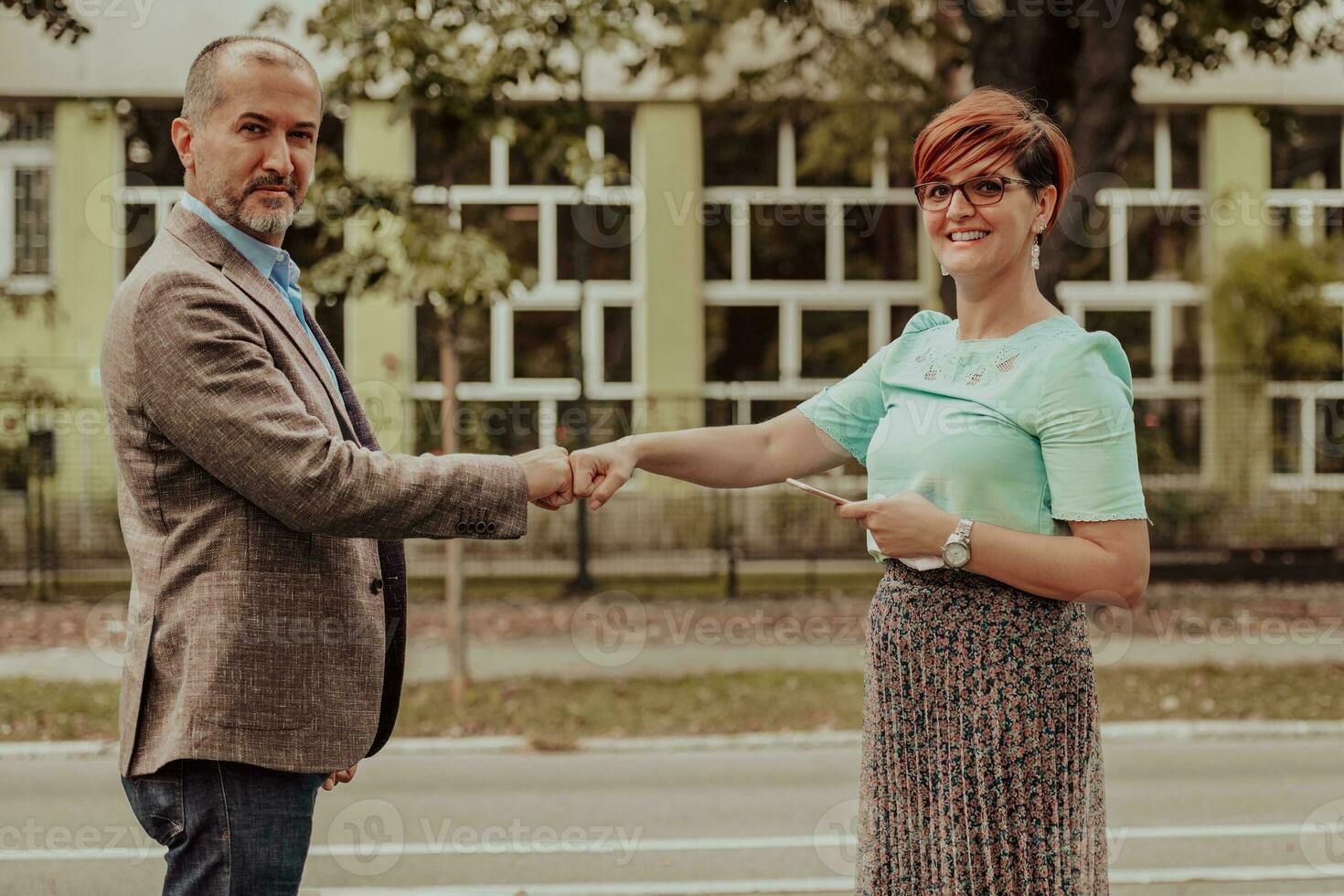 moderno mayor empresario sacudida manos con mujer en calle. foto