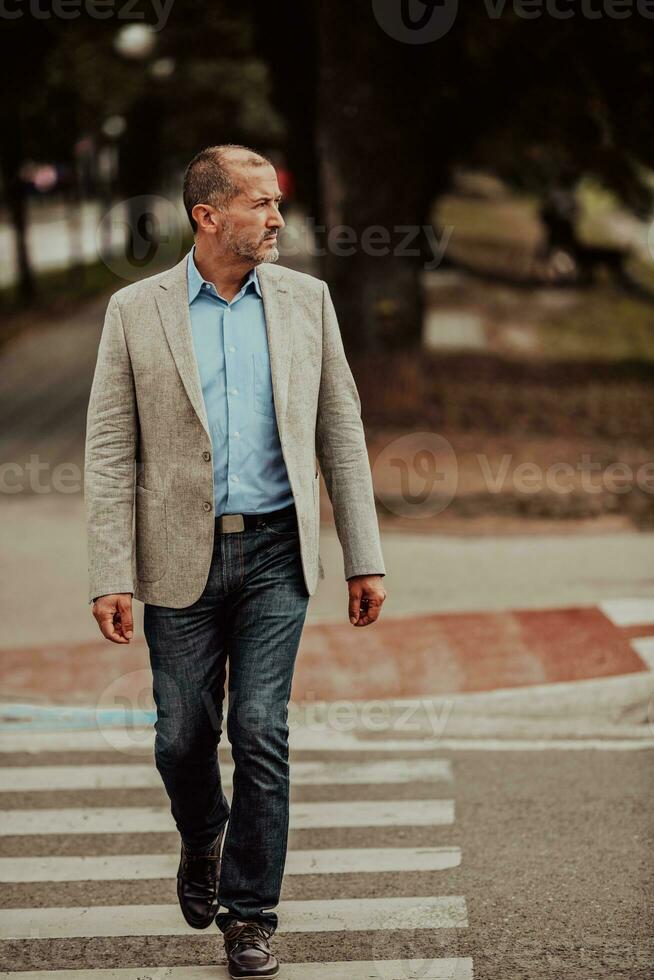 focused businessman in suit walking in urban environment. photo