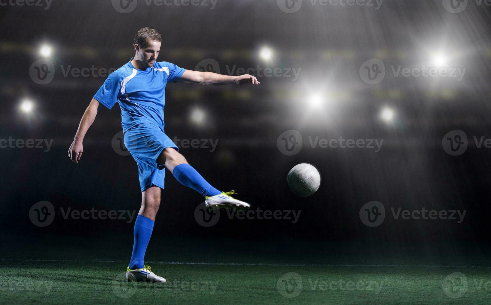 soccer player in front of big modern stadium with flares and lights photo