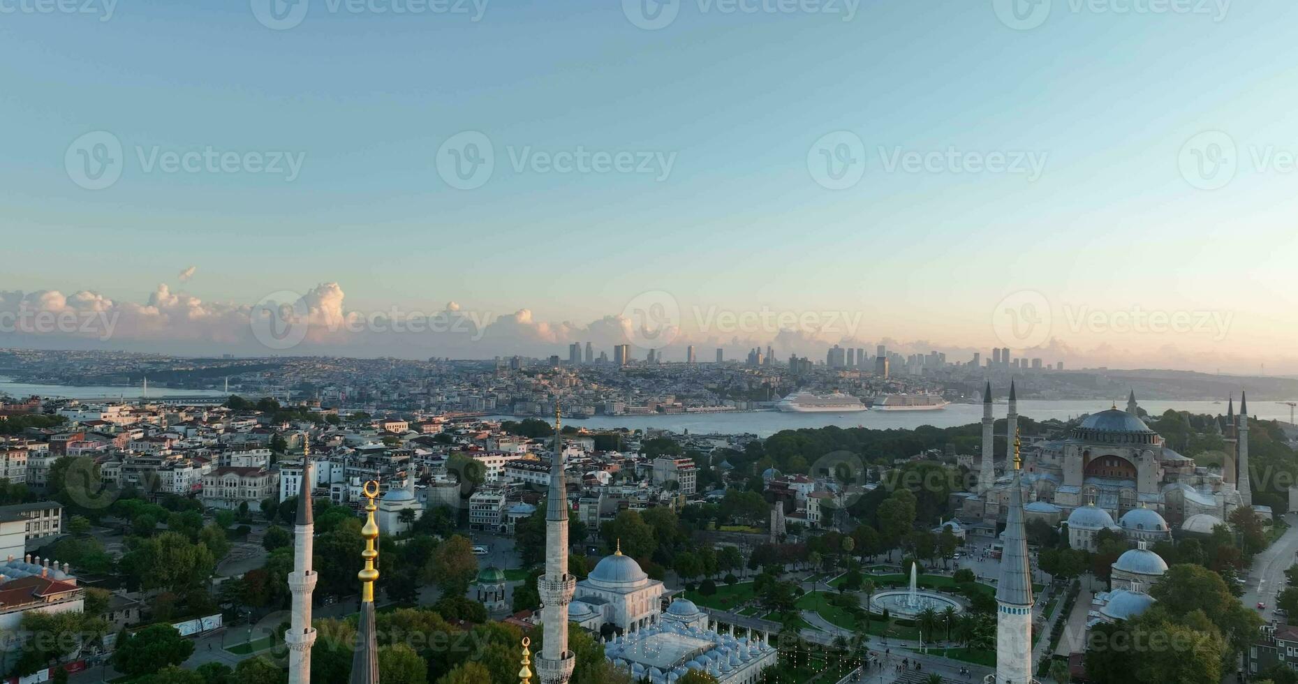 Istanbul, Turkey. Sultanahmet area with the Blue Mosque and the Hagia Sophia with a Golden Horn and Bosphorus bridge in the background at sunrise. photo