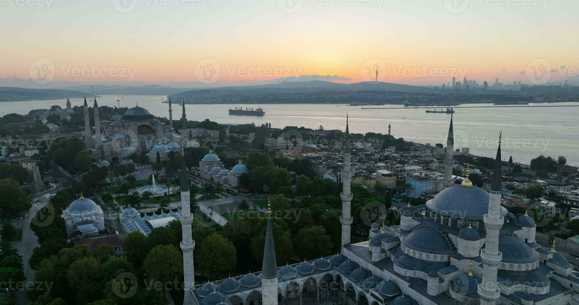 Istanbul, Turkey. Sultanahmet area with the Blue Mosque and the Hagia Sophia with a Golden Horn and Bosphorus bridge in the background at sunrise. photo