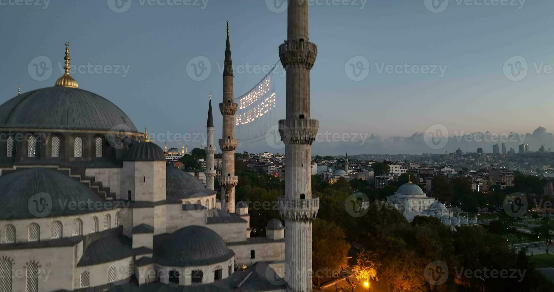 Istanbul, Turkey. Sultanahmet with the Blue Mosque and the Hagia Sophia with a Golden Horn on the background at sunrise. Cinematic Aerial view. photo