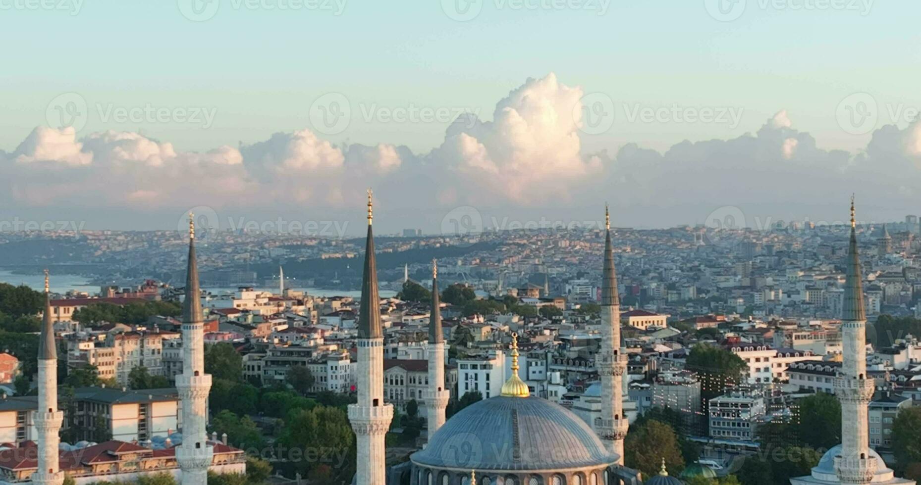 Istanbul, Turkey. Sultanahmet with the Blue Mosque and the Hagia Sophia with a Golden Horn on the background at sunrise. Cinematic Aerial view. photo