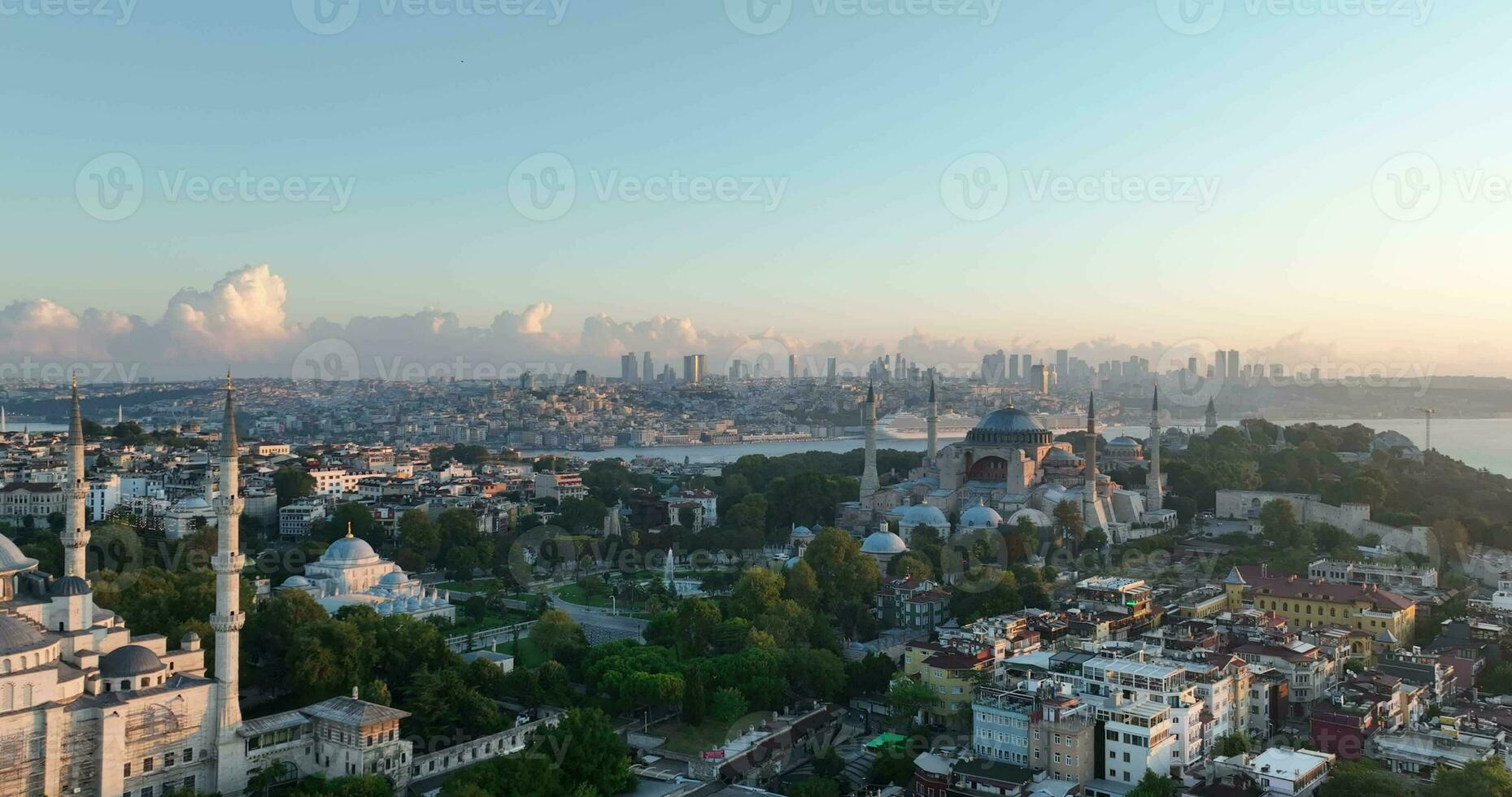 Istanbul, Turkey. Sultanahmet with the Blue Mosque and the Hagia Sophia with a Golden Horn on the background at sunrise. Cinematic Aerial view. photo