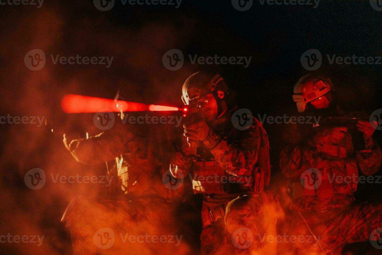 Soldiers squad in action on night mission using laser sight beam lights military team concept photo