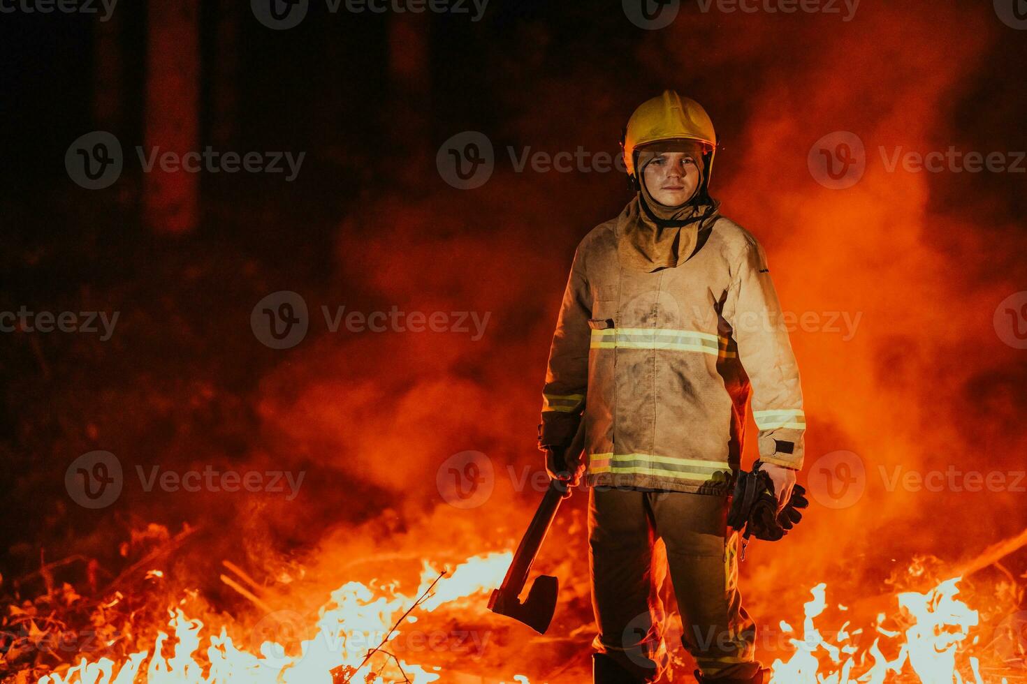 Firefighter at job. Firefighter in dangerous forest areas surrounded by strong fire. Concept of the work of the fire service photo