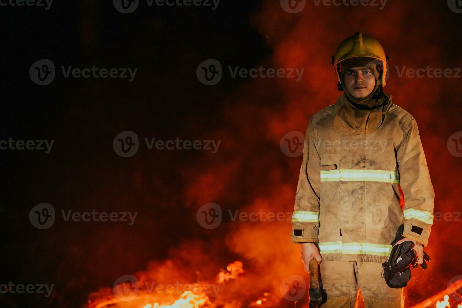 Firefighter at job. Firefighter in dangerous forest areas surrounded by strong fire. Concept of the work of the fire service photo