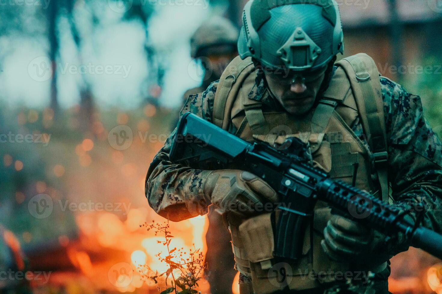 Soldier in Action at Night in the Forest Area. Night Time Military Mission jumping over fire photo