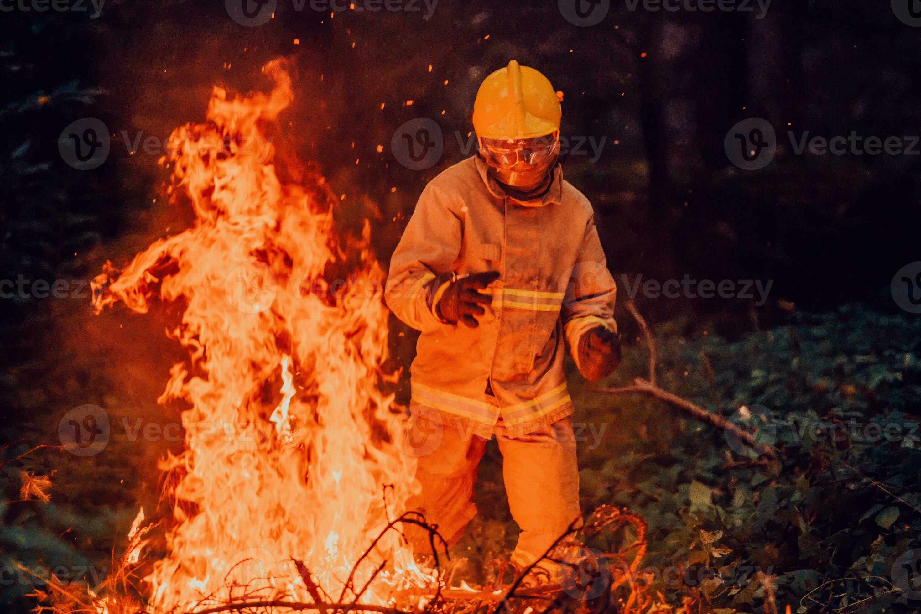 firefighter hero in action danger jumping over fire flame to rescue and firefighter hero in action danger jumping over fire flame to rescue and