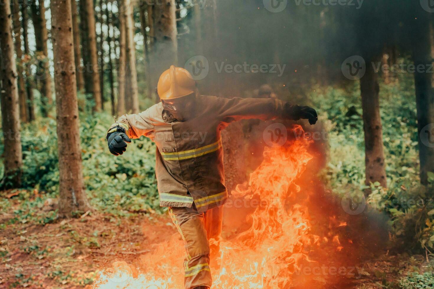 firefighter hero in action danger jumping over fire flame to rescue and save photo