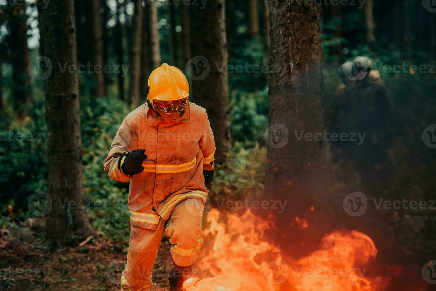 firefighter hero in action danger jumping over fire flame to rescue and