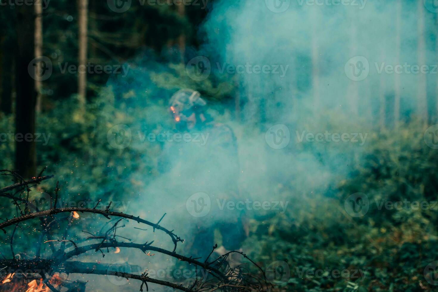 A soldier fights in a warforest area surrounded by fire photo