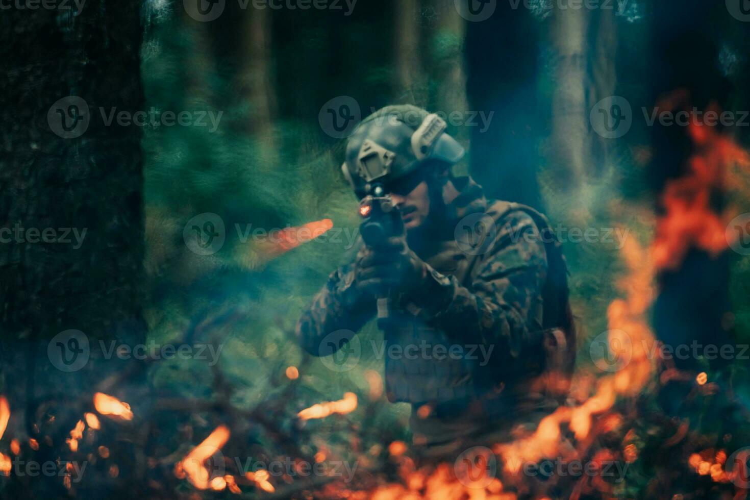 A soldier fights in a warforest area surrounded by fire photo