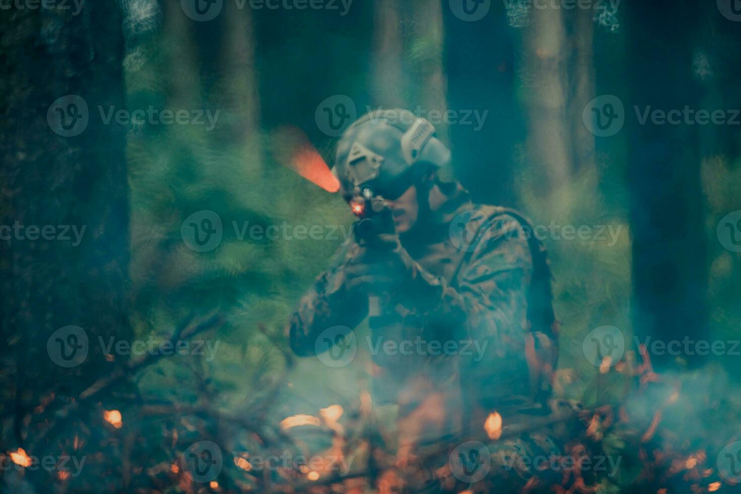 A soldier fights in a warforest area surrounded by fire photo