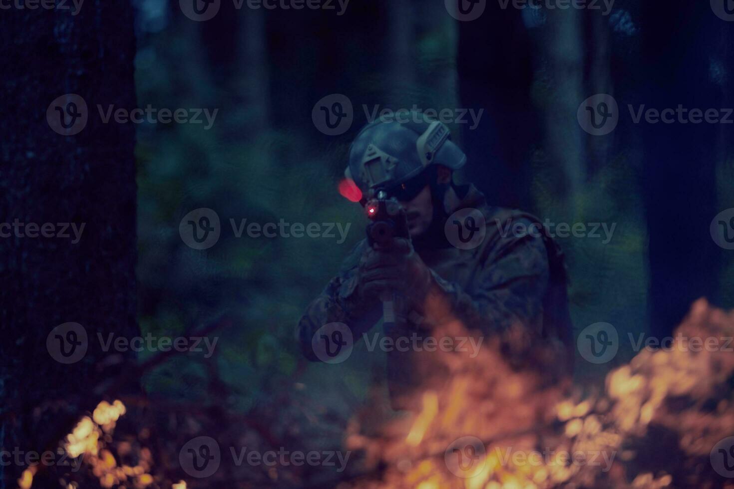 soldier in action aiming  on weapon  laser sight optics photo