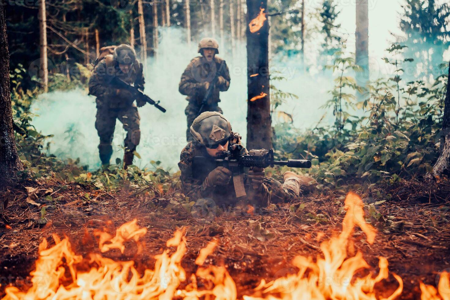 Modern warfare soldiers surrounded by fire fight in dense and dangerous forest areas photo