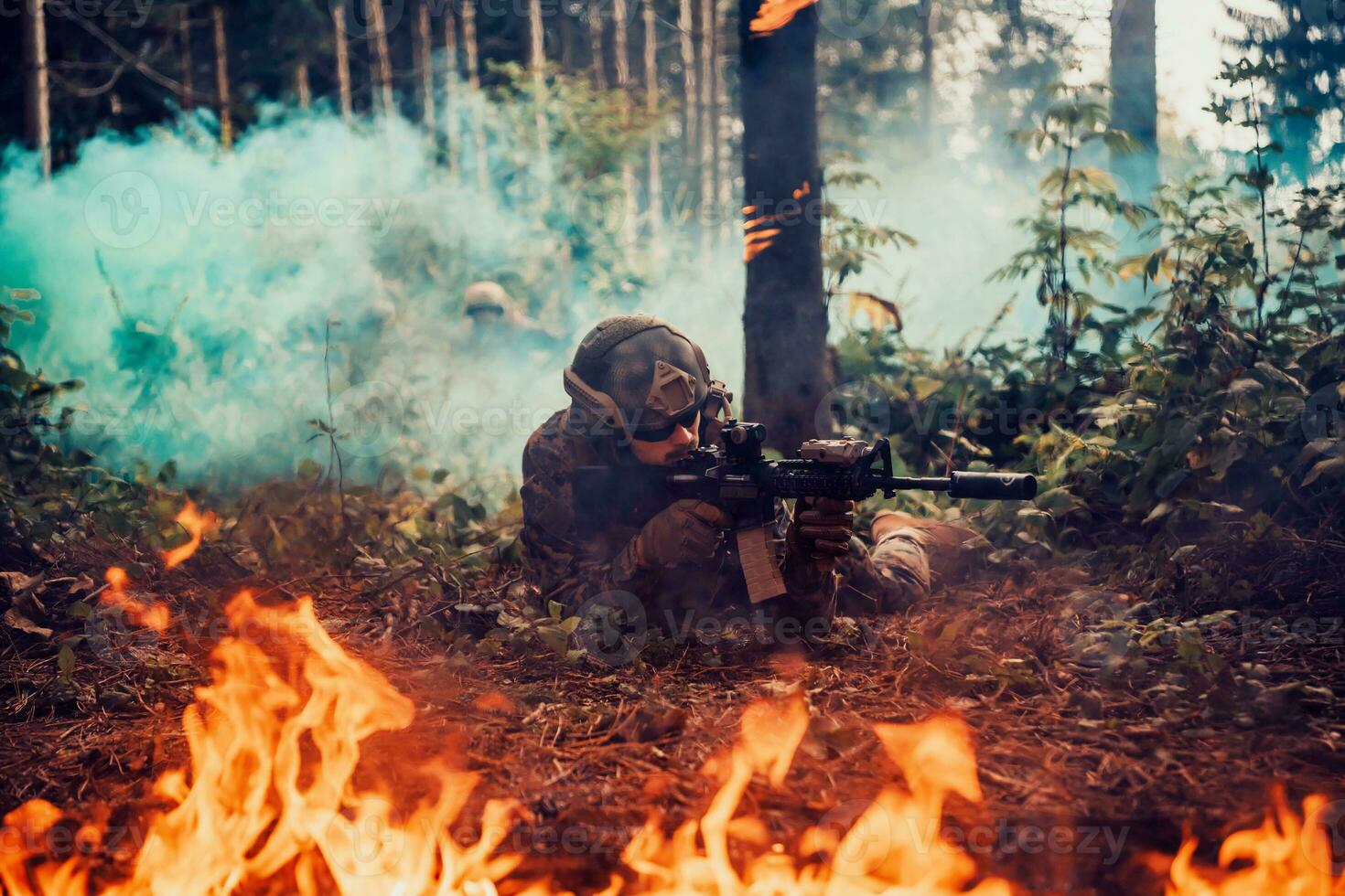 Modern warfare soldier surrounded by fire, fight in dense and dangerous forest areas photo