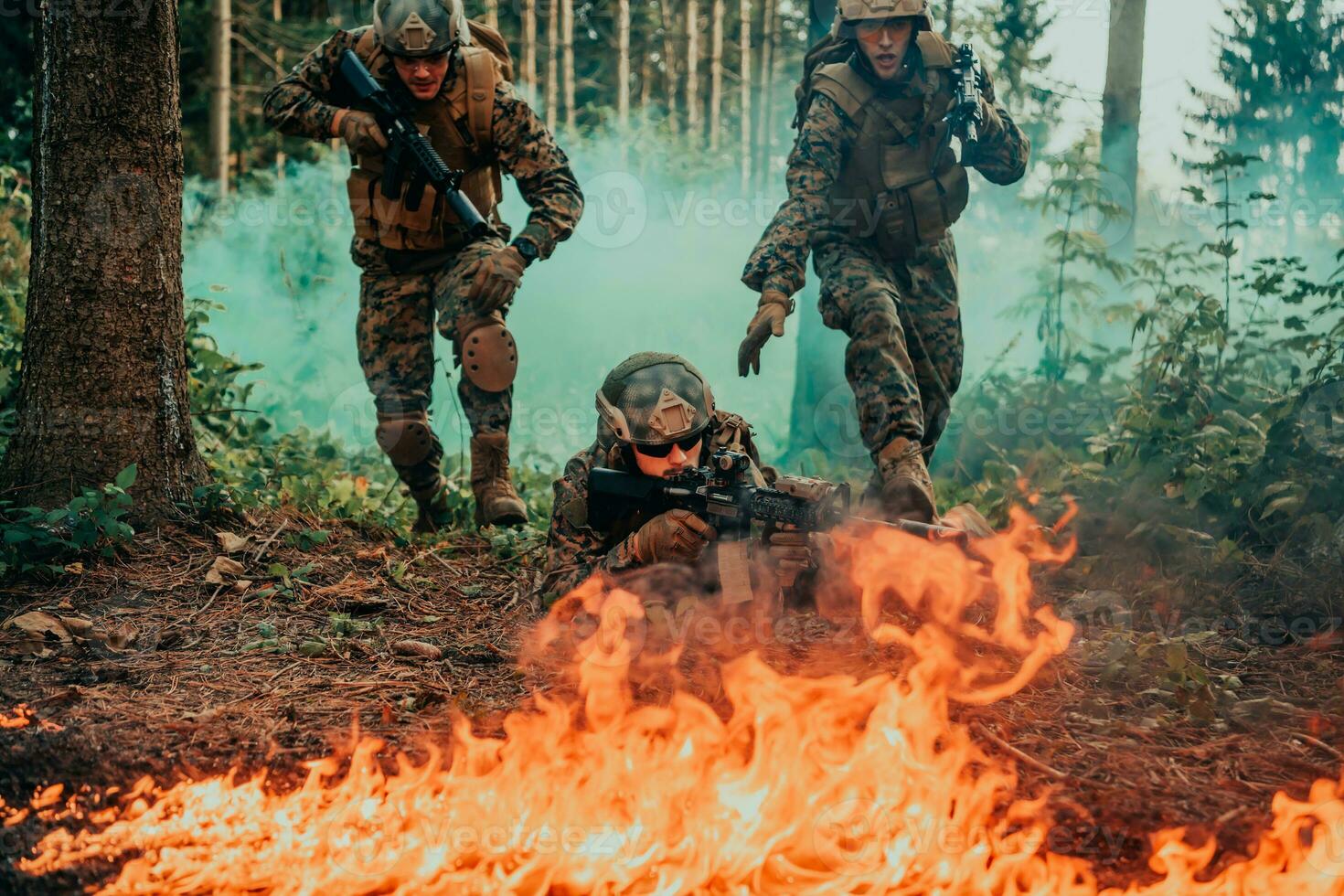 Modern warfare soldiers surrounded by fire fight in dense and dangerous forest areas photo