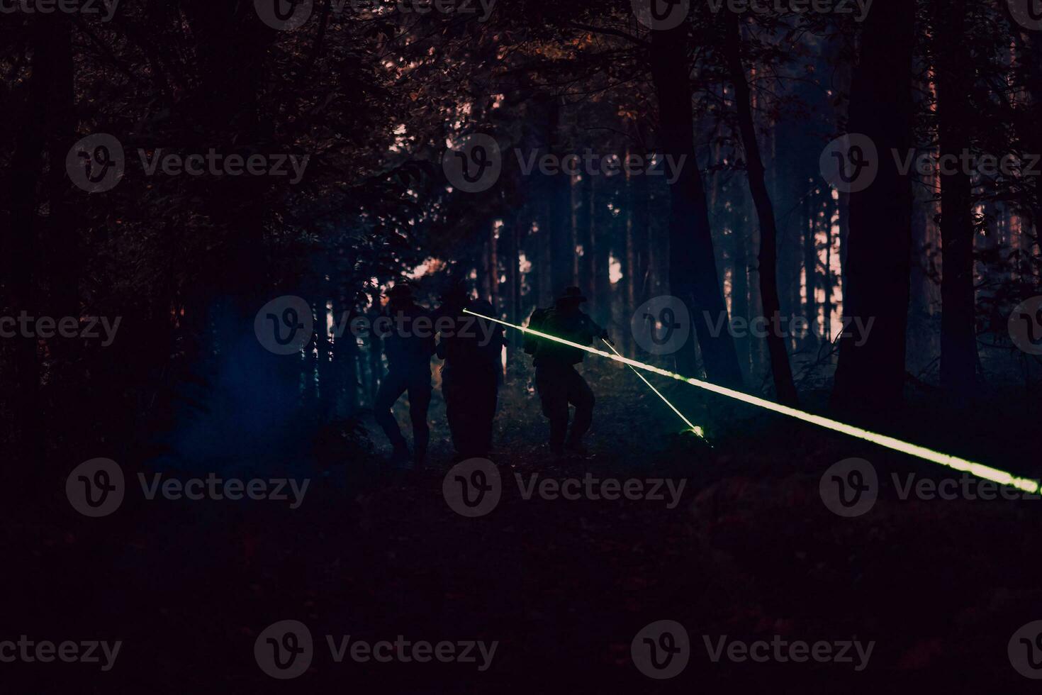 Soldiers squad in action on night mission using laser sight beam lights military team concept photo